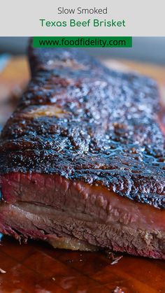 a close up of a steak on a cutting board with text overlay reading slow smoked texas beef brisket