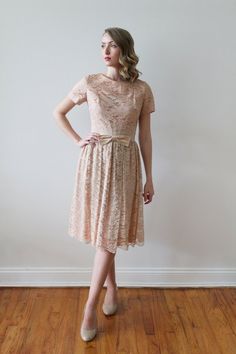 Vintage 1950's short sleeved dusty rose lace party dress with satin bow detail. Blush lace over blush fabric. A champagne satin fabric around the waist with blush lace over top. Satin champagne fabric bow in the front. Pleating in the skirt all around the waist. Dress in excellent condition!*Dress was pinned to fit model.MeasurementsApproximately a US women's size 4-6. Please check your own measurements and compare to those below. Model shown wears a dress size 2.Shoulders: 14" / Sleeve Length: Beige Lace Dress With Short Sleeves For Party, Beige Short Sleeve Lace Dress For Wedding, Beige Short Sleeve Lace Party Dress, 1950s Shorts, Champagne Fabric, Blush Fabric, Lace Party Dress, Top Satin, Lace Party Dresses