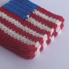 three red, white and blue crocheted dishcloths sitting on top of each other