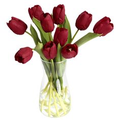 a vase filled with red flowers on top of a table