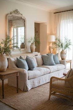 a living room filled with furniture and a large mirror on the wall above it's headboard