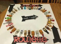 a table topped with lots of bottles and magnets next to a sign that says rouleette