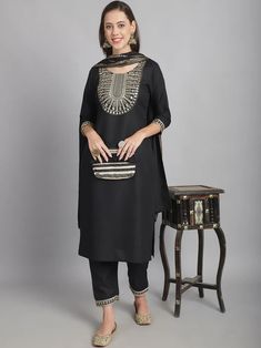 Grab this beautiful 3-piece set. The set comes with embroidery detailing kurta has round neck; 3/4th sleeves & calf length teamed with matching trouser pant and a cotton blend dupatta. Color - Black Kurta Fabric-Cotton Blend Pant Fabric-Cotton Blend Dupatta Fabric - Cotton Blend Neck-Round Neck Sleeves-3/4th Sleeves Work - Sequence Embroidery Detailing Washing Instructions-Dry Clean Model Height - 5.5 wearing size small. DISCLAIMER - The color of the product may be differ due to screen settings of device. A misprint here and a color drop slip there is the beauty of printing which is not treated as a defect. Eid Pant Set With Embroidered Straight Kurta, Festive Cotton Pant Set With Mirror Work, Black Cotton Sets With Mirror Work, Bollywood Style Pant Set With Mirror Work, Festive Straight Kurta Pant Set With Mirror Work, Festive Pant Set With Mirror Work And Straight Kurta, Festive Embroidered Pant Set With Straight Kurta, Traditional Straight Kurta Pant Set With Embroidered Border, Bollywood Embroidered Straight Kurta Pant Set