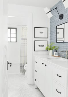 a bathroom with blue and white tiles on the walls