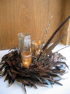 there is a candle holder with feathers on it