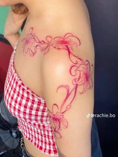 a woman's breast with pink flowers on it