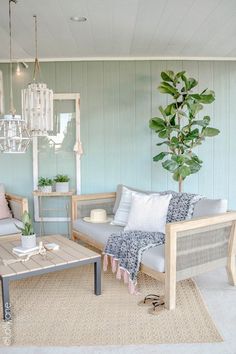 a living room filled with furniture and a potted plant on top of a table