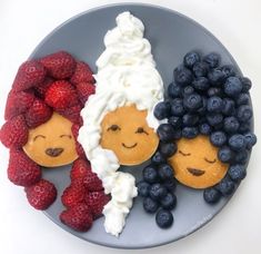 a plate with pancakes, berries and blueberries on it