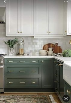 the kitchen is clean and ready for us to use it's green cabinetry