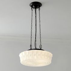 a chandelier hanging from the ceiling in a room with white walls and flooring