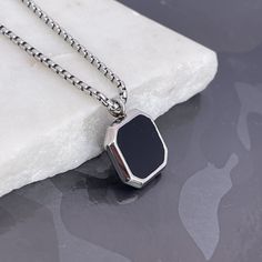 "Elevate her style with our Black Onyx Stone Necklace for Men, a stainless steel pendant ready for custom engraving. The perfect gift designed for her, these handmade jewelry pieces add sophistication to any look. Express your love with a special message, initials, or date, and make it a special treasure. Convey individuality and charm with a timeless piece. Presented in a durable and stylish style, this makes a lovely Valentine's Day gift for a husband or lover. \"Personalize Your Style\" and m Black Stainless Steel Jewelry With Black Enamel, Black Engraved Rectangular Pendant Necklaces, Black Engraved Rectangular Pendant Necklace, Stainless Steel Box Chain Necklace With Square Pendant, Black Personalized Dog Tag Necklace, Black Jewelry With Engraving Option For Father's Day, Minimalist Black Jewelry With Engraving Option, Engraved Gunmetal Pendant Jewelry, Elegant Black Jewelry With Engraving Option