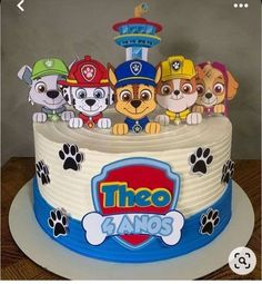 there is a birthday cake decorated with paw patrol characters on the front and back sides