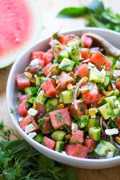 a white bowl filled with watermelon and cucumber salad