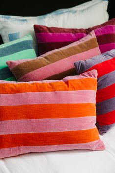 colorful striped pillows stacked on top of each other