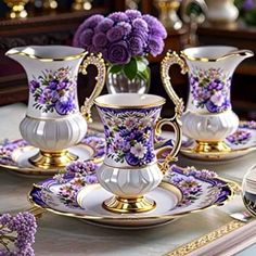 purple flowers are in the vases and on the plate, along with other decorative items