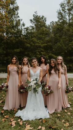 a group of women standing next to each other on top of a lush green field