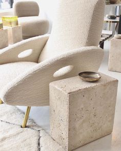 a chair and ottoman made out of concrete blocks