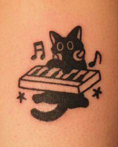 a black cat with music notes on it's chest