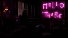 a person standing in a dark room with a neon sign on the wall that says hello there