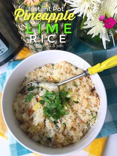 a white bowl filled with rice and garnished with cilantro next to a pineapple