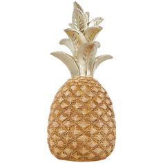 a golden pineapple shaped vase sitting on top of a table