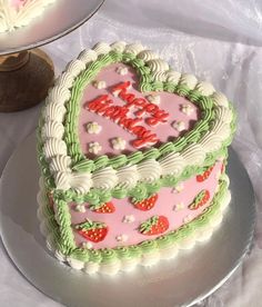 a heart shaped birthday cake on a table