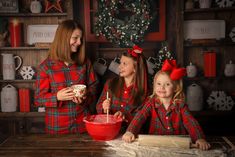 three girls in matching red and green outfits are making christmas cookies while one girl is holding a bowl