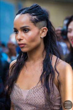 a woman with long black hair and braids