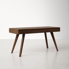 a wooden table sitting on top of a white floor