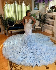 a woman is standing in front of a large blue feathered rug on the floor