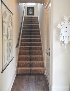 an image of a staircase with snowflakes on the wall and wood flooring