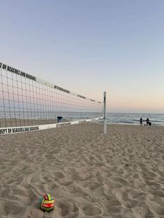 a beach volleyball net and ball on the sand