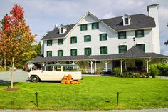 a van parked in front of a large white building