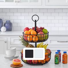 two tiered fruit trays on a kitchen counter