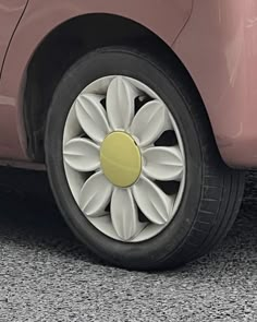 a red car with white flowers on it's tire