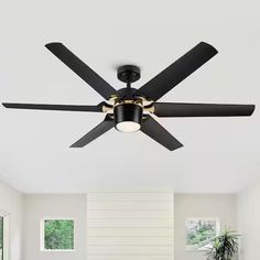 a black ceiling fan in a white room