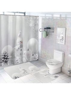 a bathroom with a shower curtain, toilet and rugs on the floor in front of it