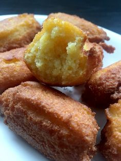 several pieces of doughnut on a white plate