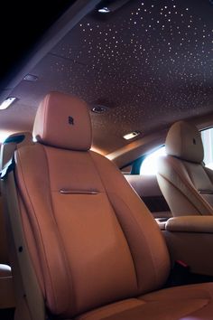 the interior of a car with star lights on the ceiling and leather seats in it