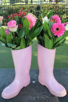 two pink rain boots with flowers in them