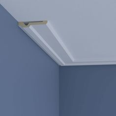 the corner of an empty room with a light fixture on it's ceiling and blue walls