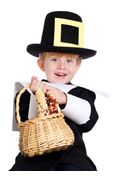 a little boy dressed in a costume and holding a basket