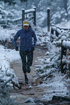 a person running in the snow on a path