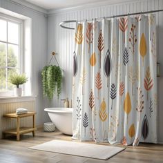 a bathroom with a bathtub, rug and shower curtain that has leaves on it