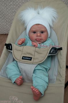 a baby in a stroller with white hair on it's head and legs