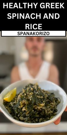 a person holding a bowl of spinach and rice