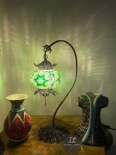 two vases and a lamp on a table