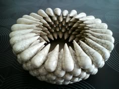 a white sculpture sitting on top of a black table