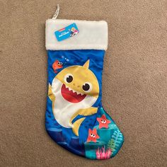 a blue christmas stocking with a shark on it