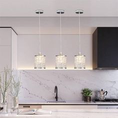 a kitchen with marble counter tops and lights hanging from the ceiling over the stove top